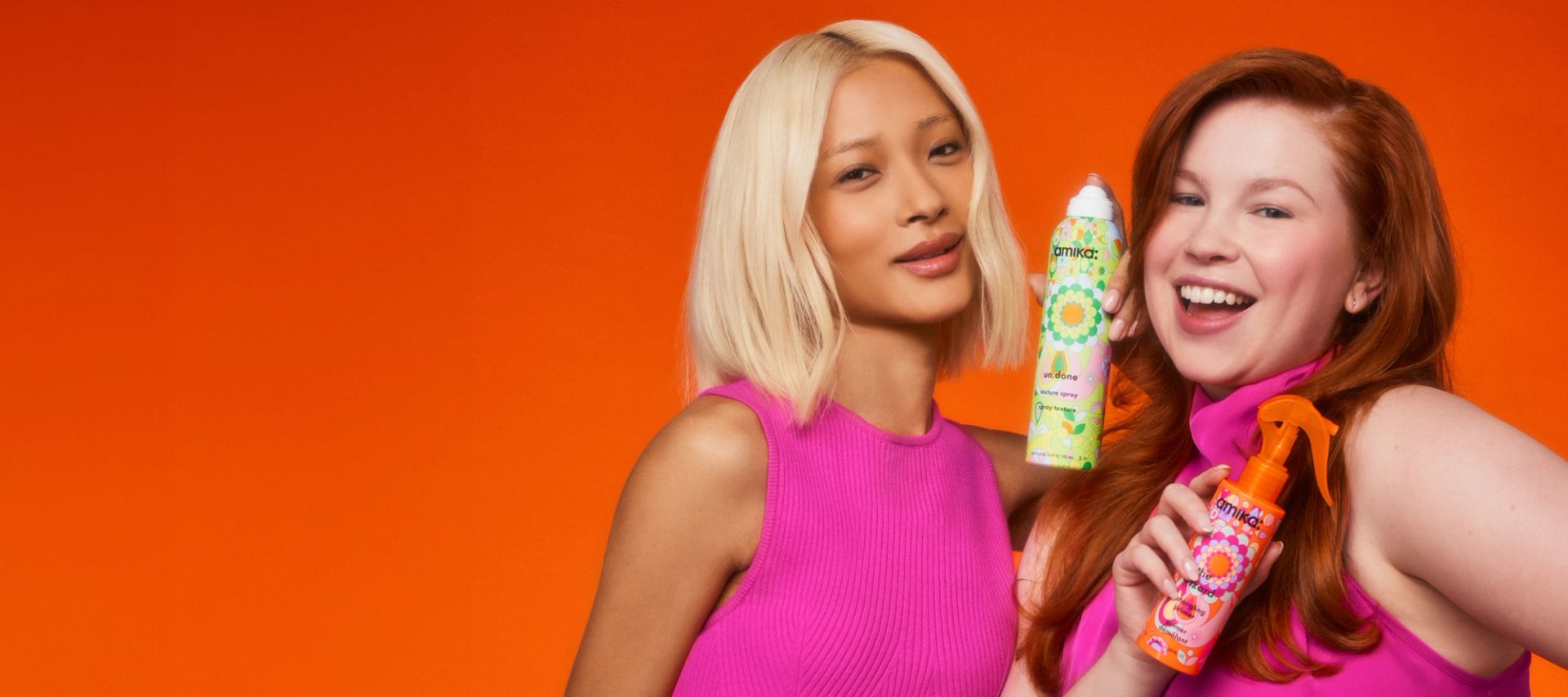 models posing in front of orange background holding un.done spray and wizard primer