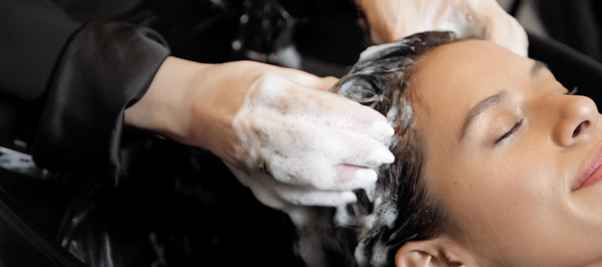 a hairstylist shampooing a client's hair