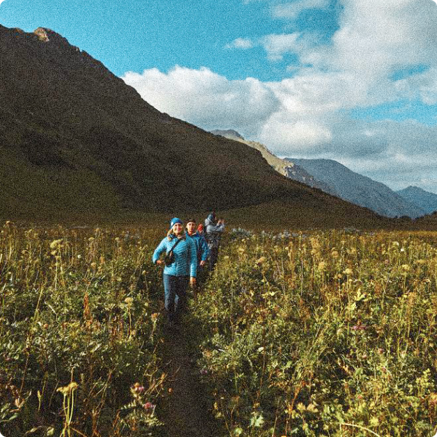 people hiking through a mountain range