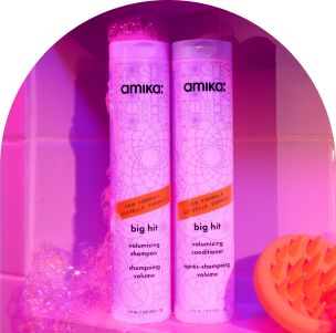 Image of our NEW big hit volumizing shampoo and conditioner against a purple tiled background.