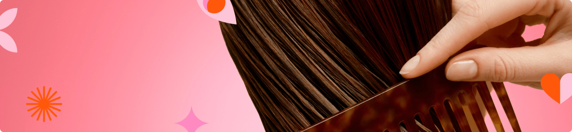 a person's hand runs a comb through brown hair against a pink gradient background