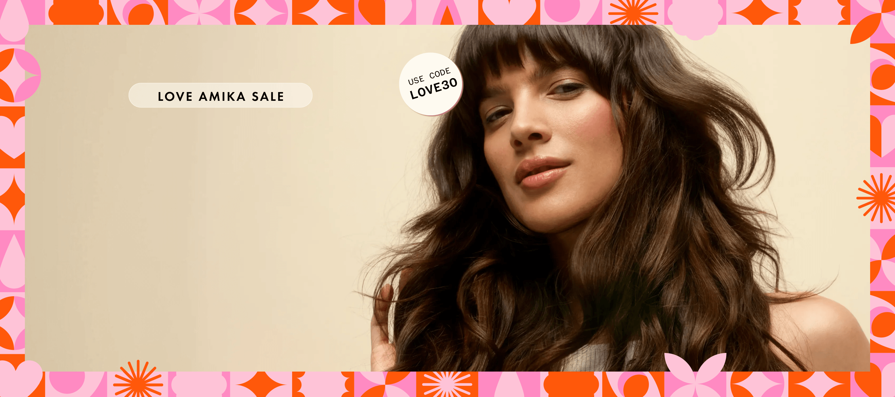 a model with brown, wavy hair stands in front of a cream background. a pink and orange pattern creates a border. stickers read "love amika sale", and "use code LOVE30"
