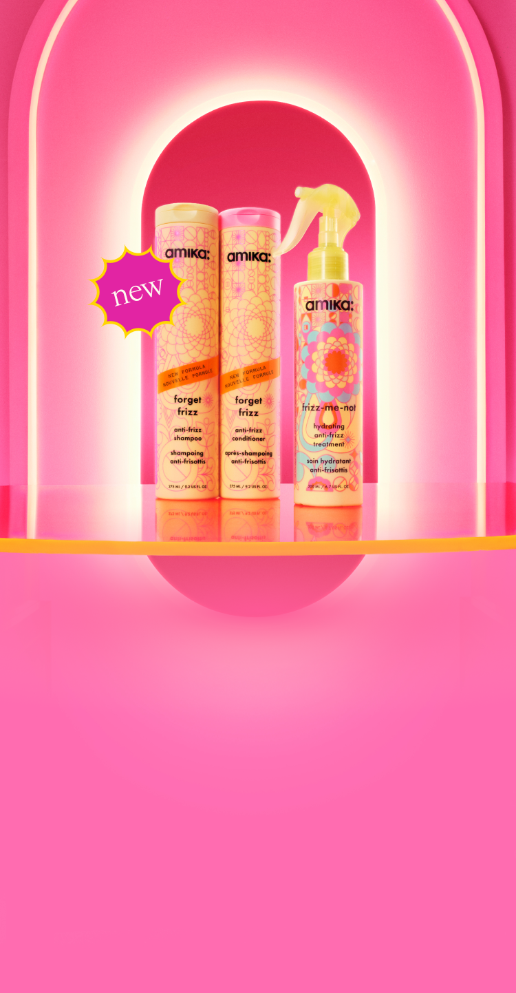 Image of the NEW frizz collection against a pink salon background. Products featured include forget frizz shampoo and conditioner alongside the frizz-me-not treatment.