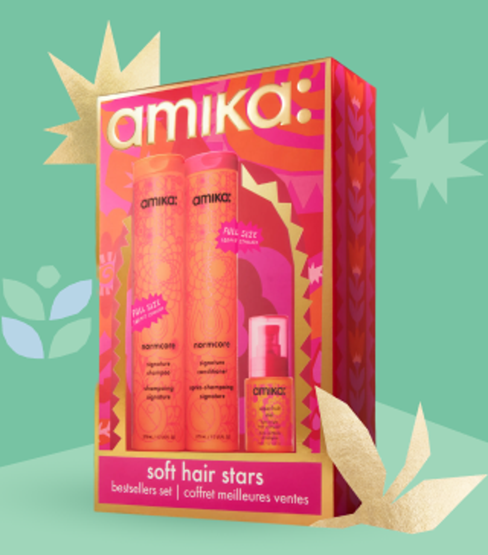 amika soft hair stars holiday gift set posed against a light green background and with some gold shapes behind the box
