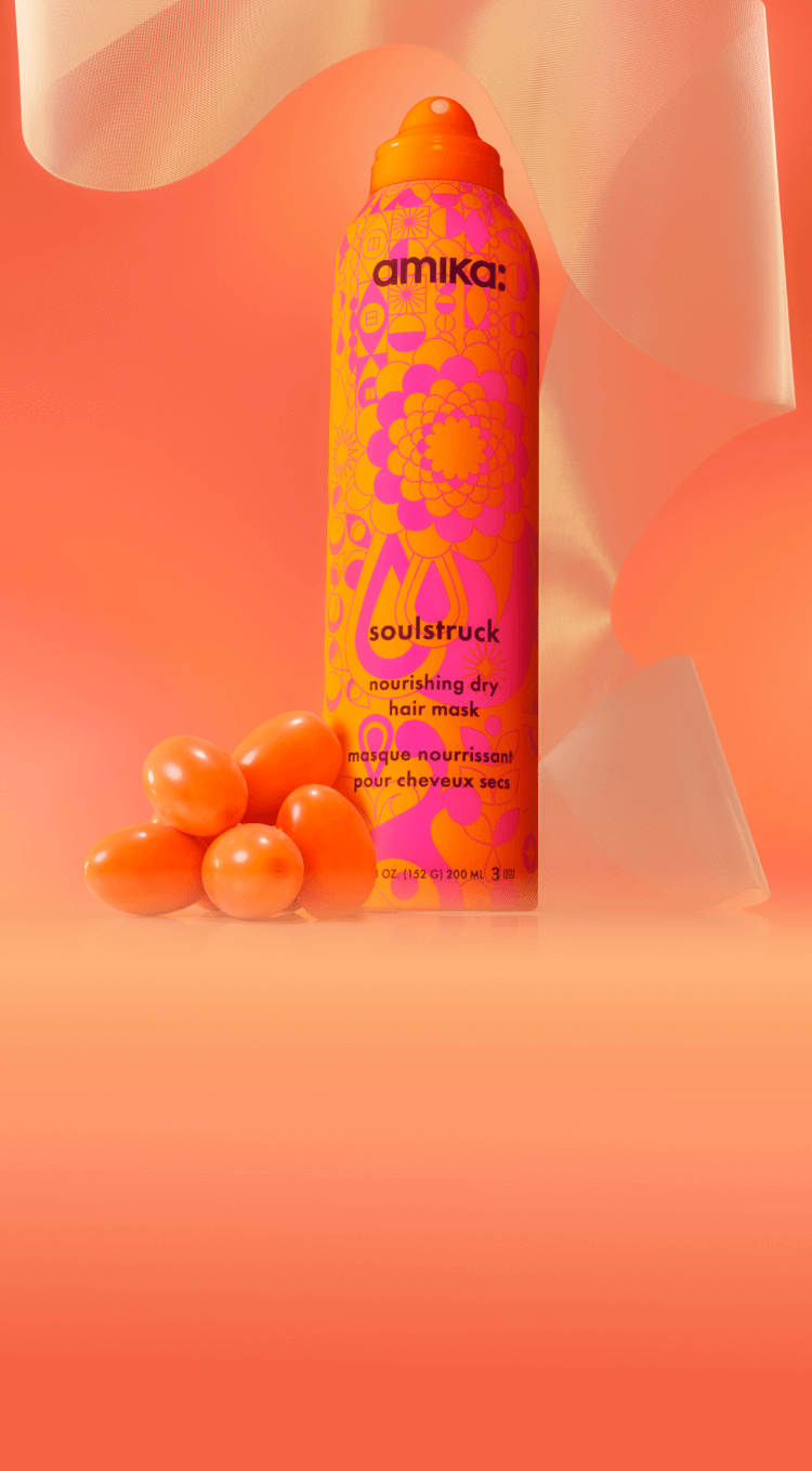 amika soulstruck spray and sea buckthorn berries in front of a amika products in front of a orange gradient background