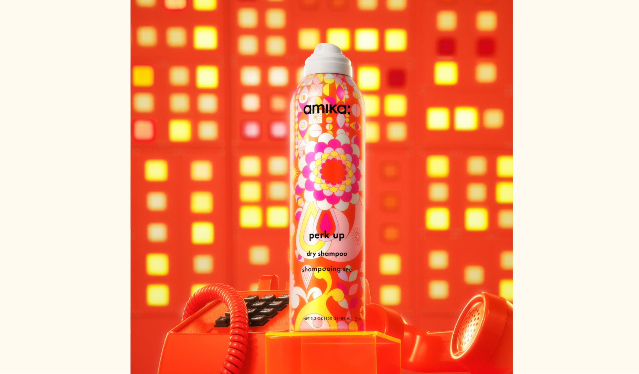 amika perk up talc-free dry shampoo spray bottle 5.3oz - pictured with an orange telephone against a geometric background