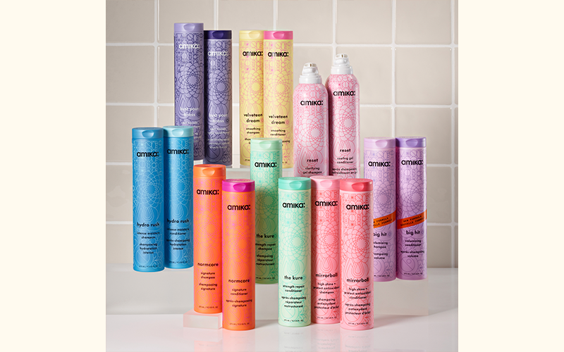 full assortment of amika shampoos and conditioners against a light gray tiled background