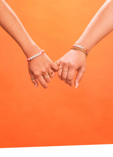 two people's pinky fingers intertwined