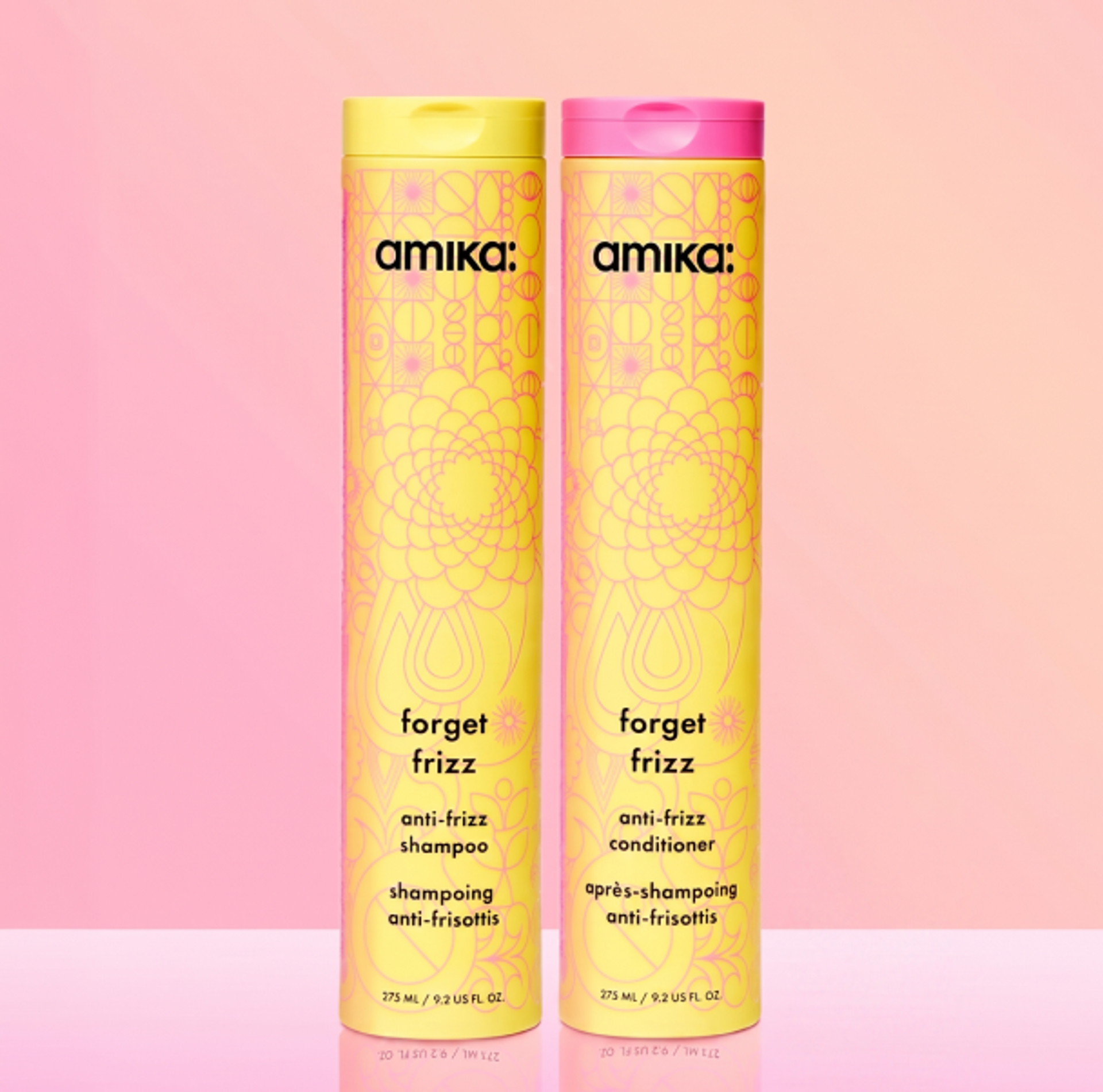 image of the forget frizz shampoo and conditioner against a pink background.