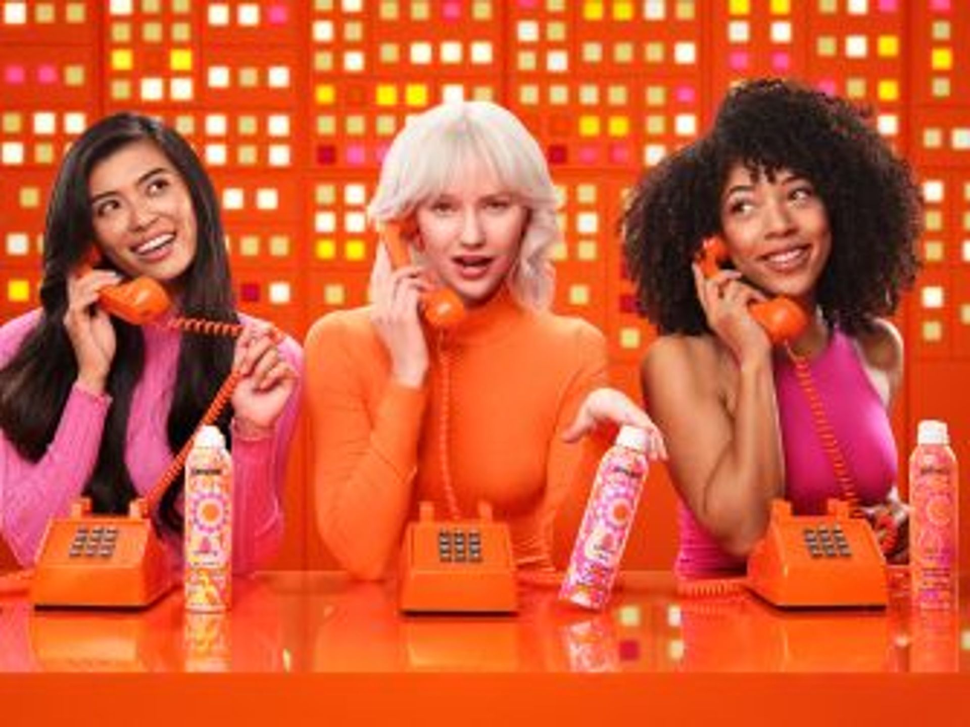 3 models talk on telephones and display amika perk up talc-free dry shampoo, perk up ultra oil control dry shampoo, and perk up plus extended clean dry shampoo.