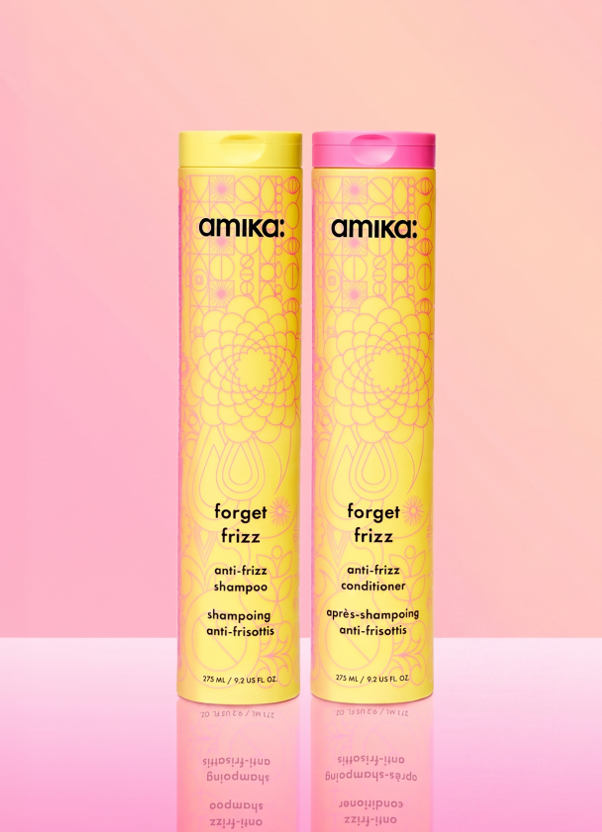 image of the forget frizz shampoo and conditioner against a pink background.