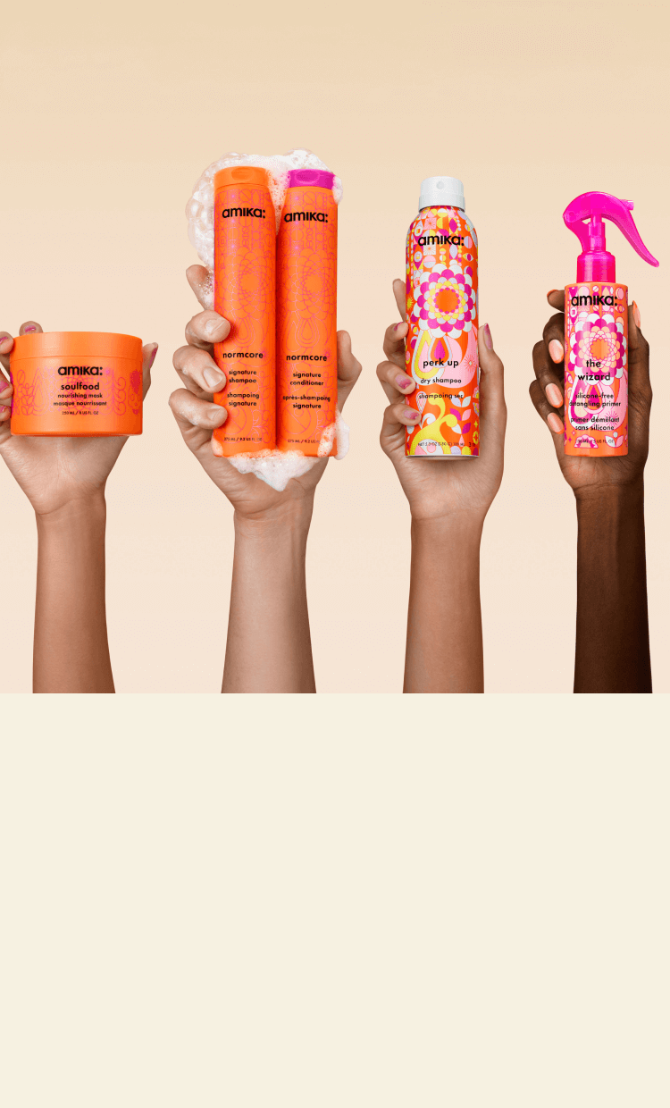 image of amika signature collection hero products: normcore shampoo + conditioner, perk up dry shampoo, the wizard detangling hair primer and soulfood nourishing hair mask against a cream background.