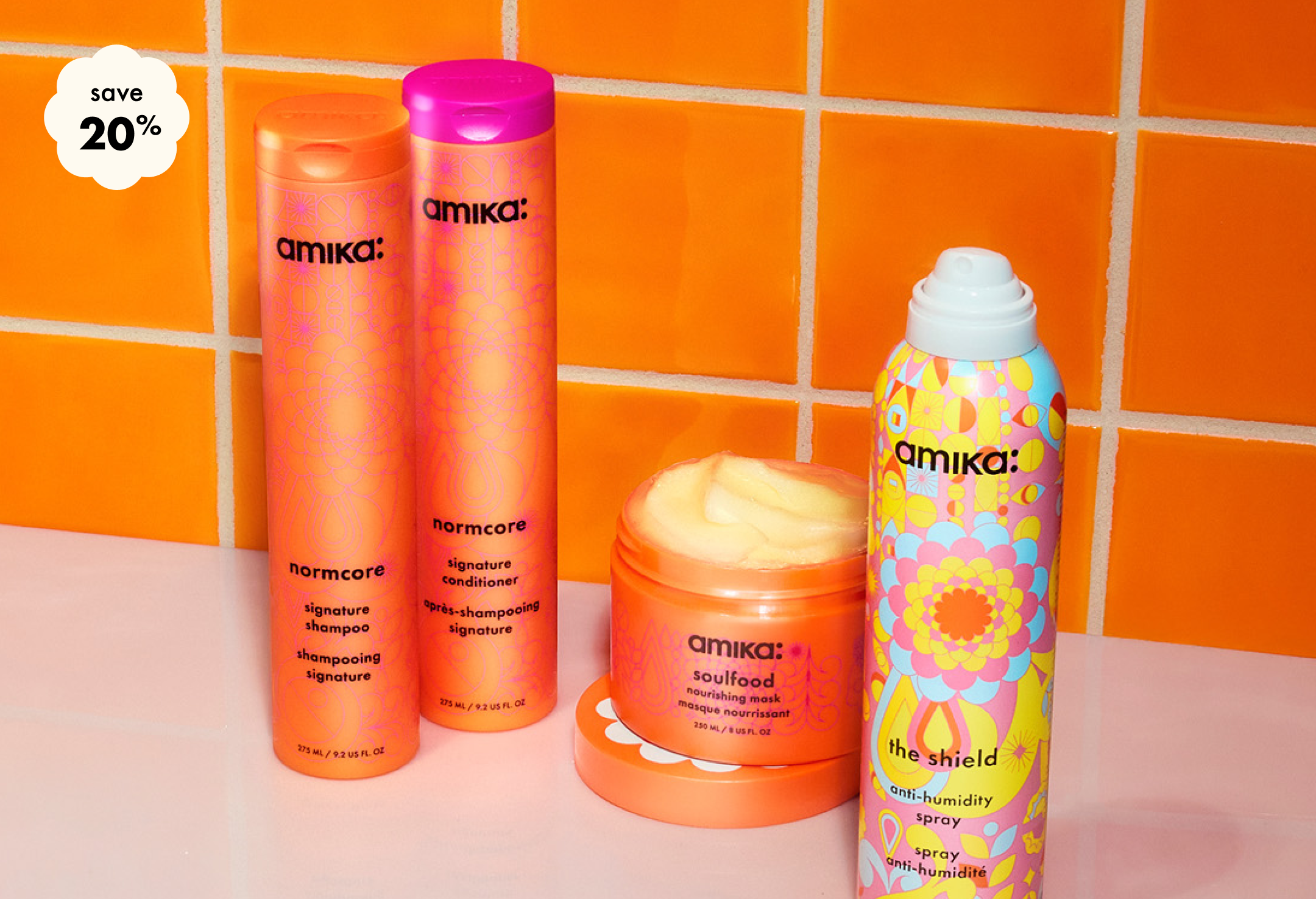 save 20% on your custom amika wash, style + treat bundle. Bottles of shampoo, conditioner, the shield spray and a jar of soulfood mask against an orange tiled background