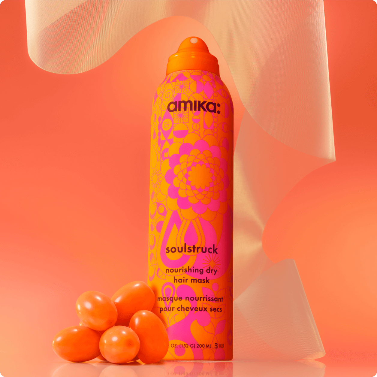 amika soulstruck spray and sea buckthorn berries in front of a amika products in front of a orange gradient background