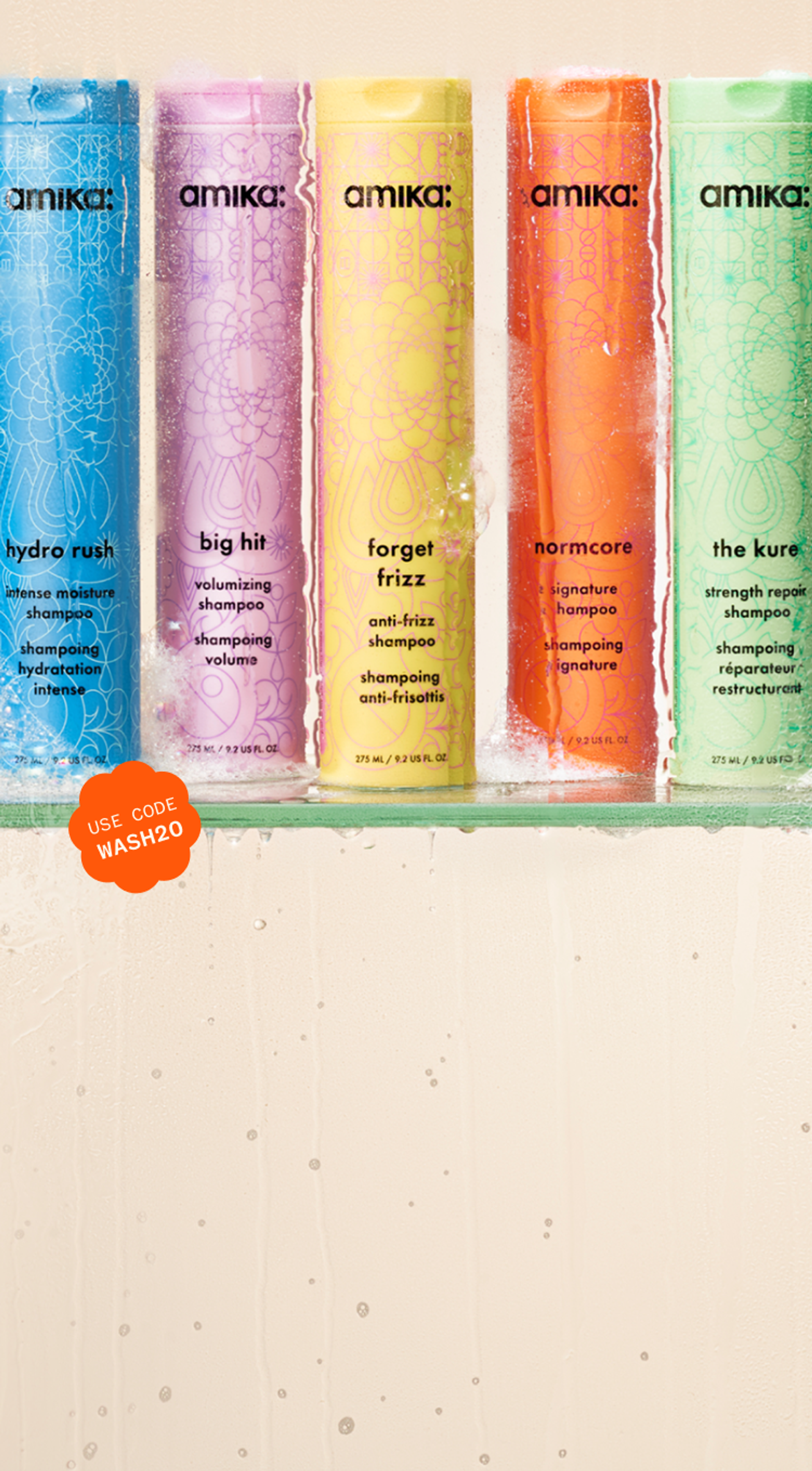 amika bottles of shampoo and conditioner in a steamy shower setting with some suds at the bottom of the surface. a sticker reads: "use code WASH20"