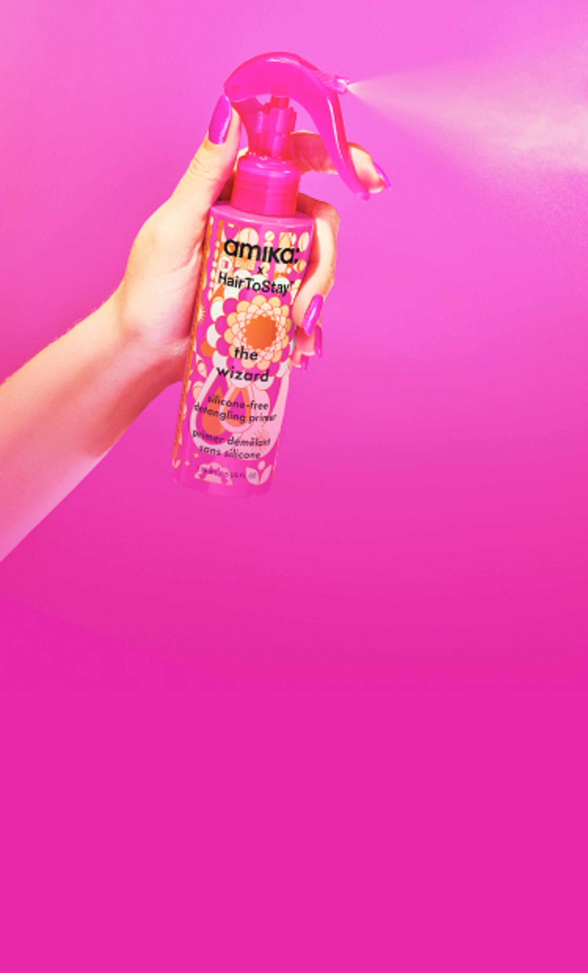 model spraying amika x HairToStay the wizard silicone-free detangling primer