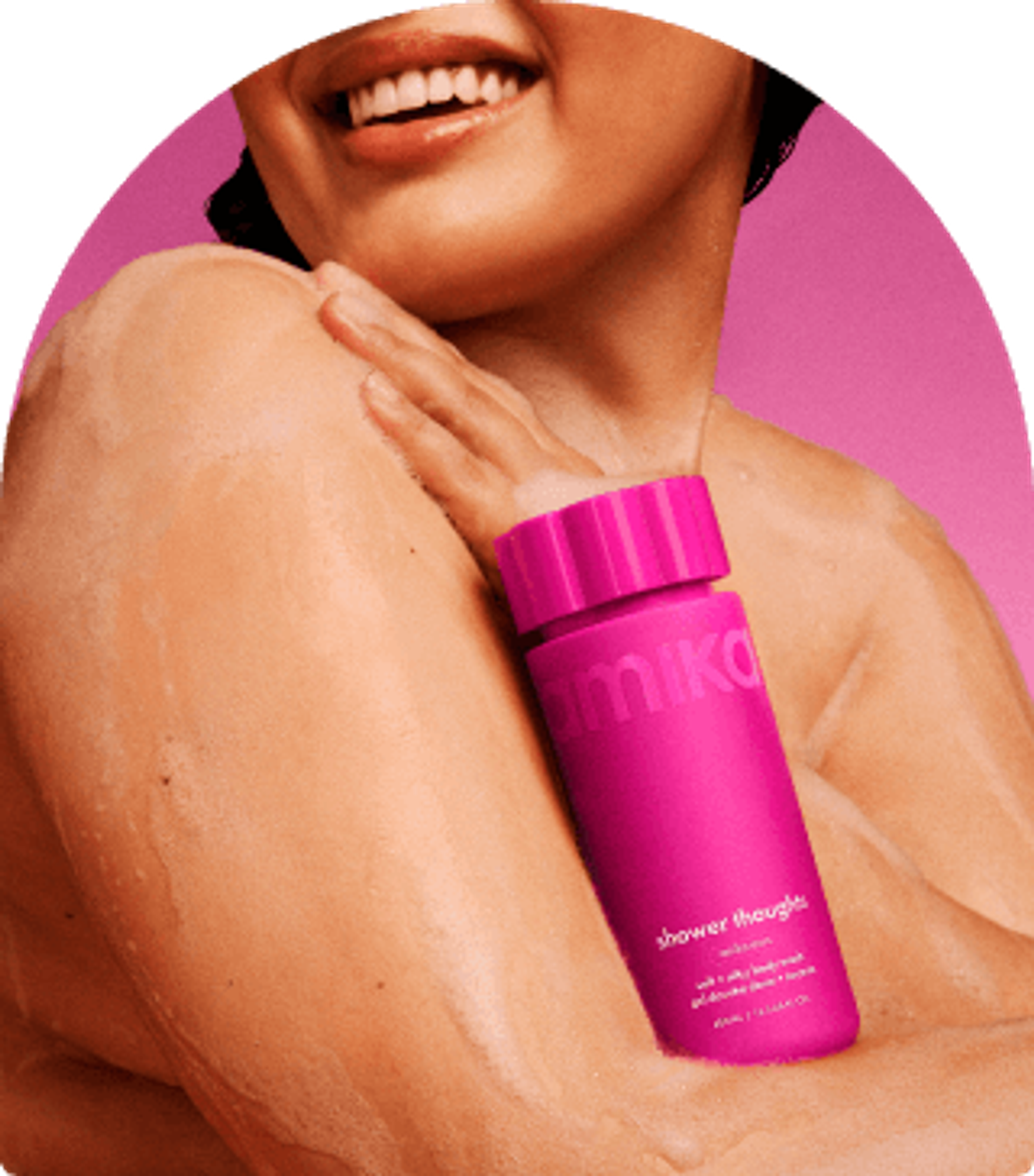 a model with lather on their skin holds amika shower thoughts against their chest. there is a pink background