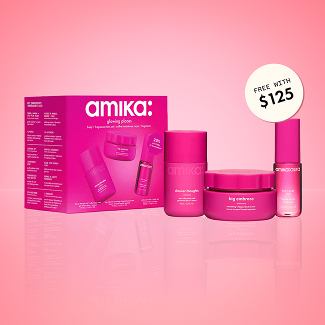 amika glowing places body + fragrance minis set stands against a pink background. a sticker reads: "free with $125" (orders)