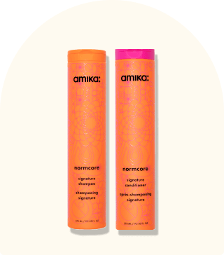 image of the normcore shampoo and conditioner against a beige background.