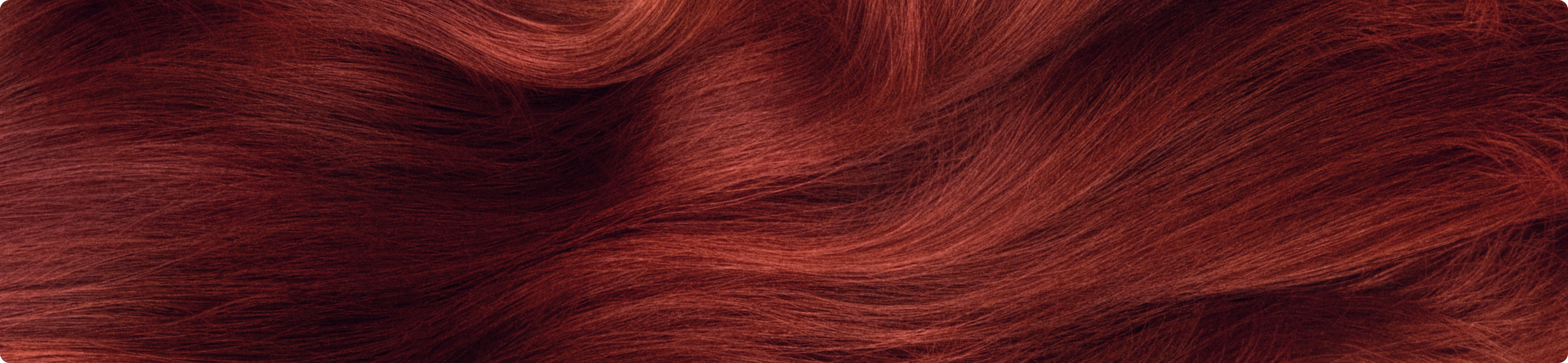close-up image of vibrant, wavy red hair