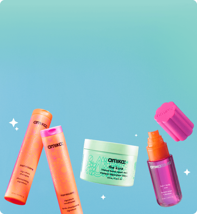 amika bottles of shampoo, mask, and hair + body fragrance mist float against a light blue background with tiny white sparkles