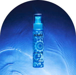 amika water sign hydrating hair oil against a blue, watery background