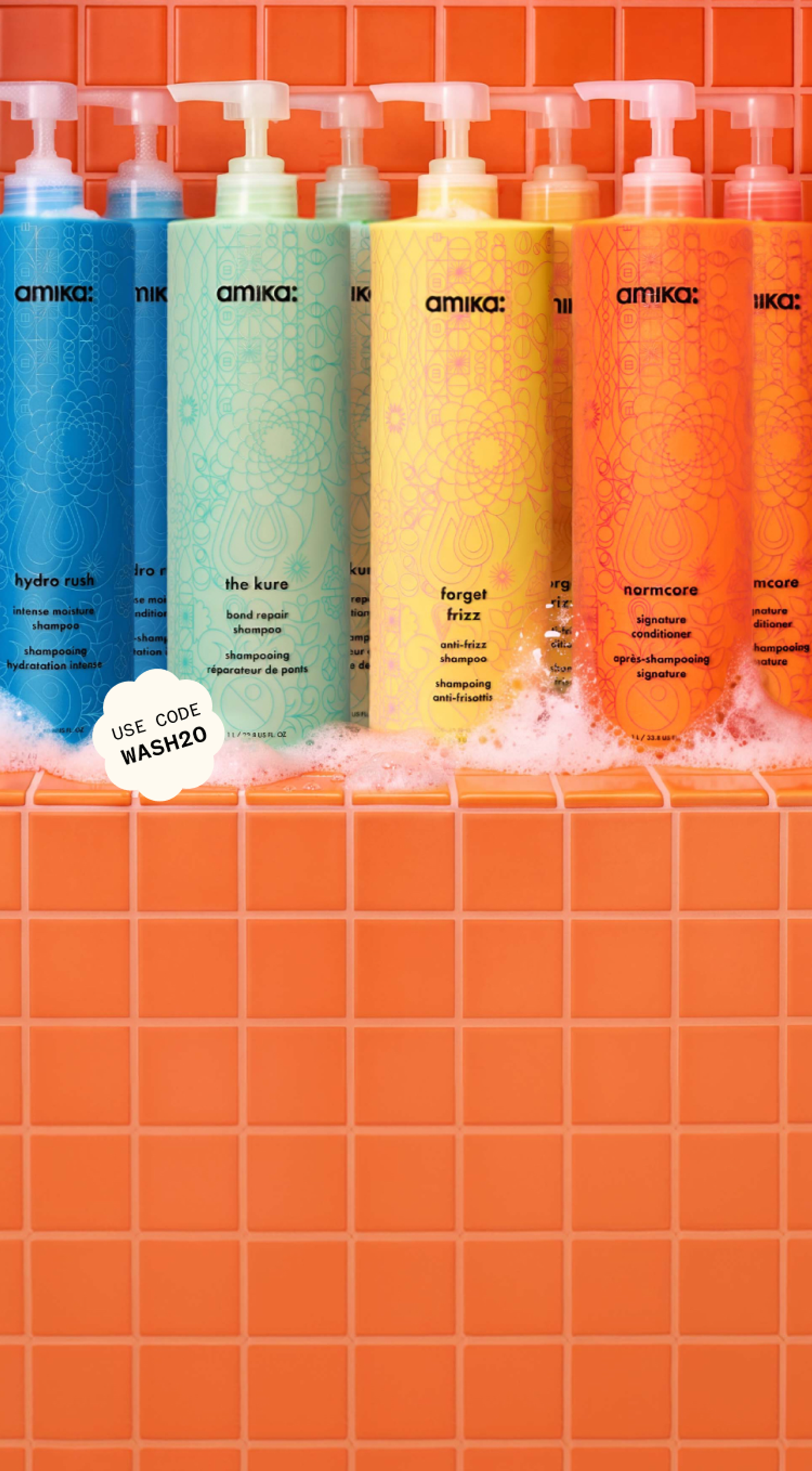 amika bottles of shampoo and conditioner against an orange tiled background with some suds at the bottom of the surface. a sticker reads: "20% OFF with code WASH20"