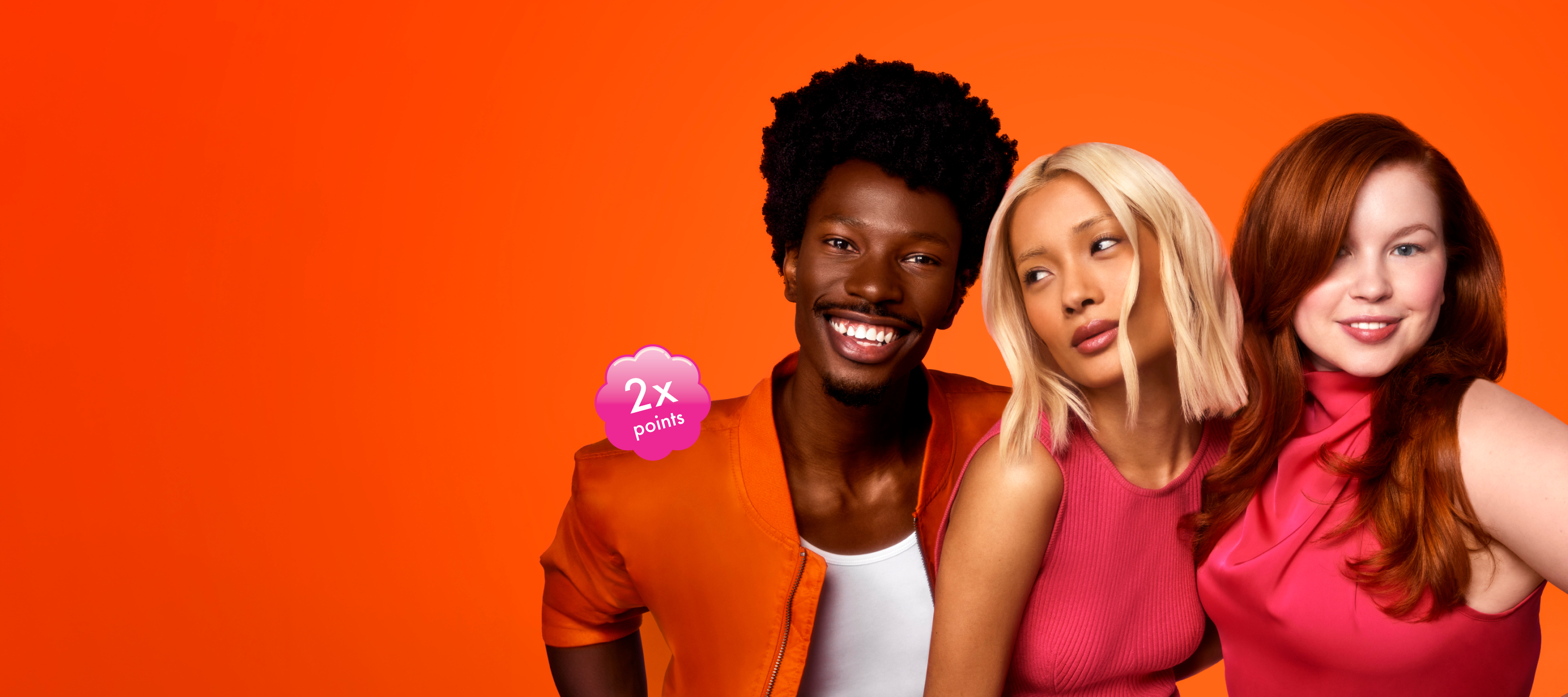 image of 3 models posing together against an orange background.