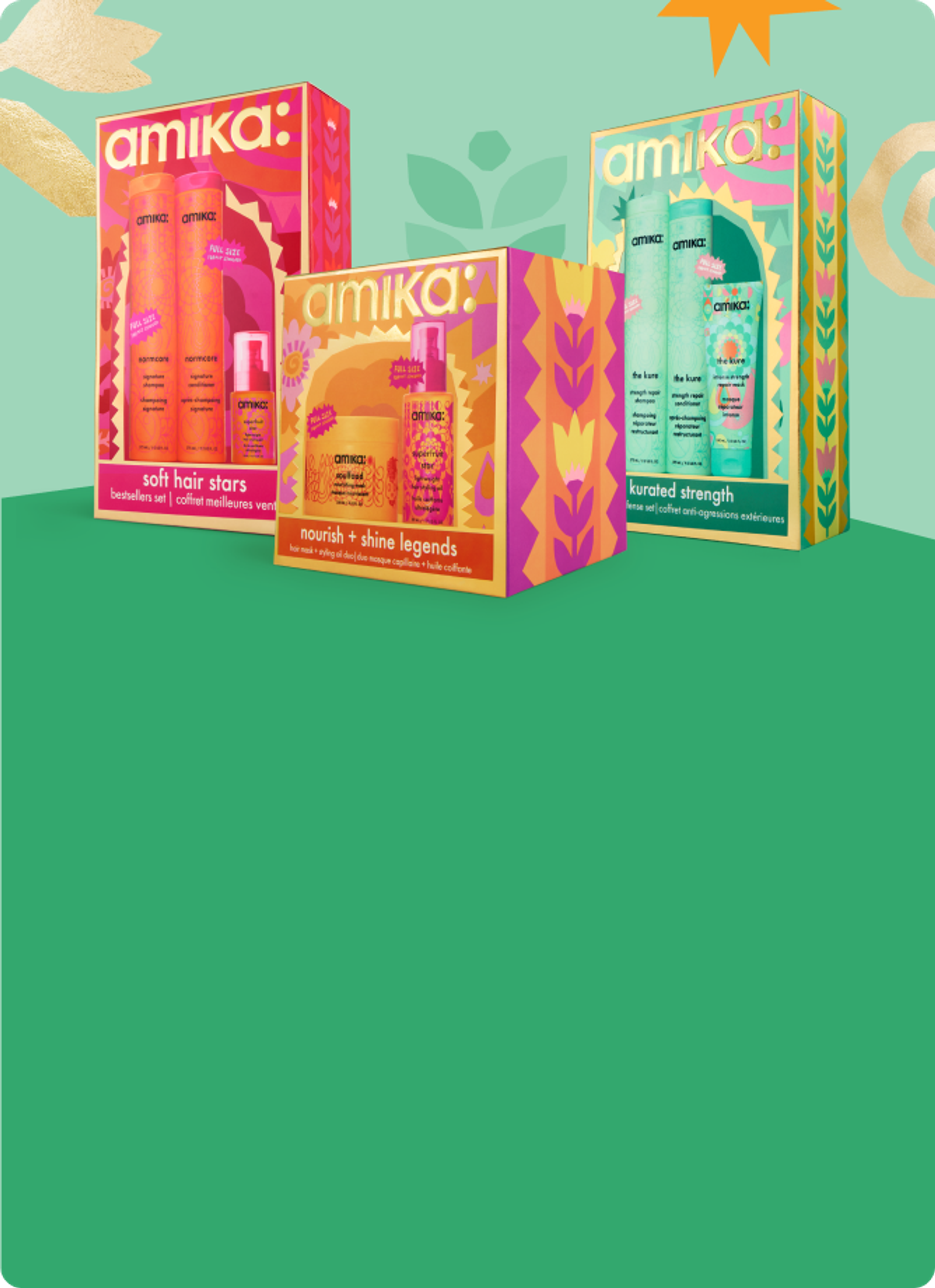 3 amika holiday gift sets against a green background with some pastel shapes behind them