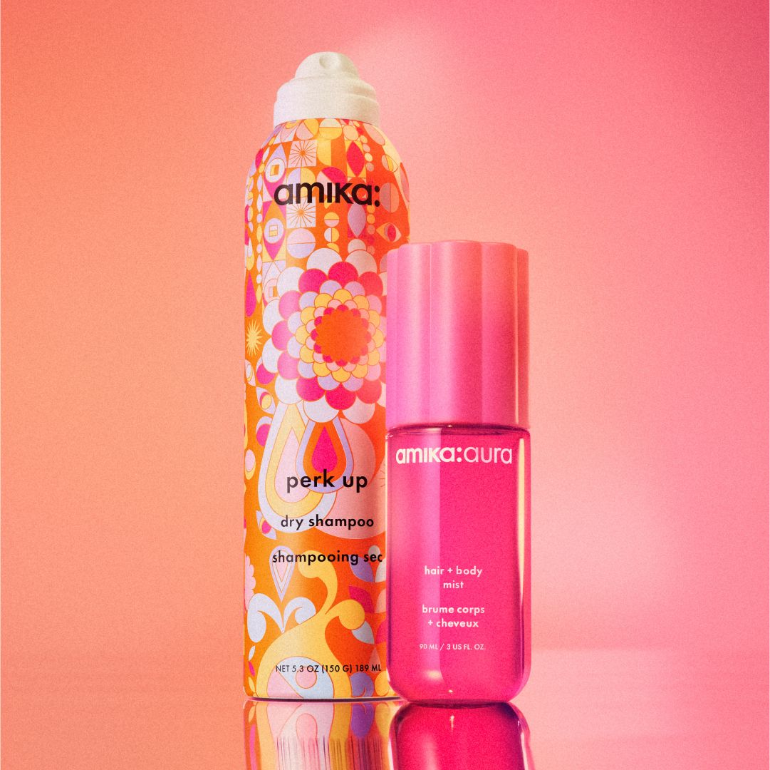 image of amika aura and perk up dry shampoo against a pink and orange background.