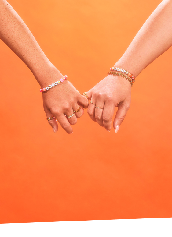 two models with pinky fingers intertwined