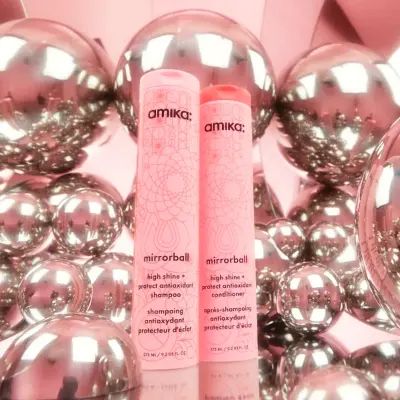 mirrorball high shine + protect antioxidant shampoo and conditioner in front of silver balls