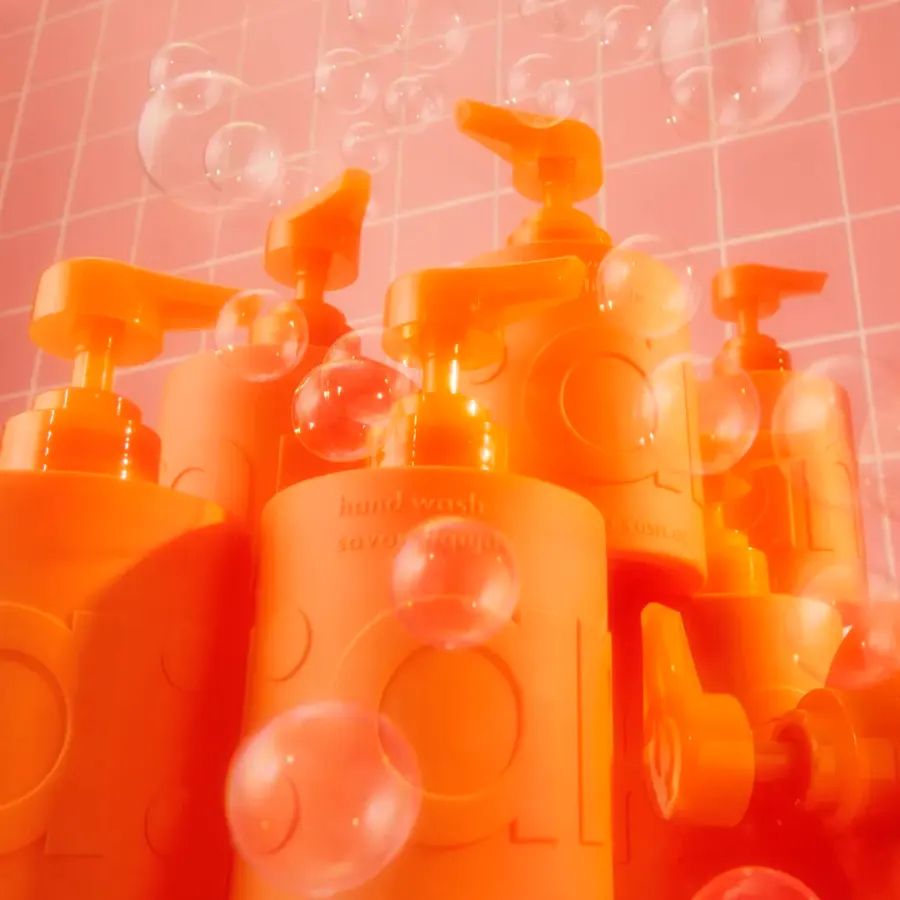 multiple hand wash bottles surrounded by bubbles