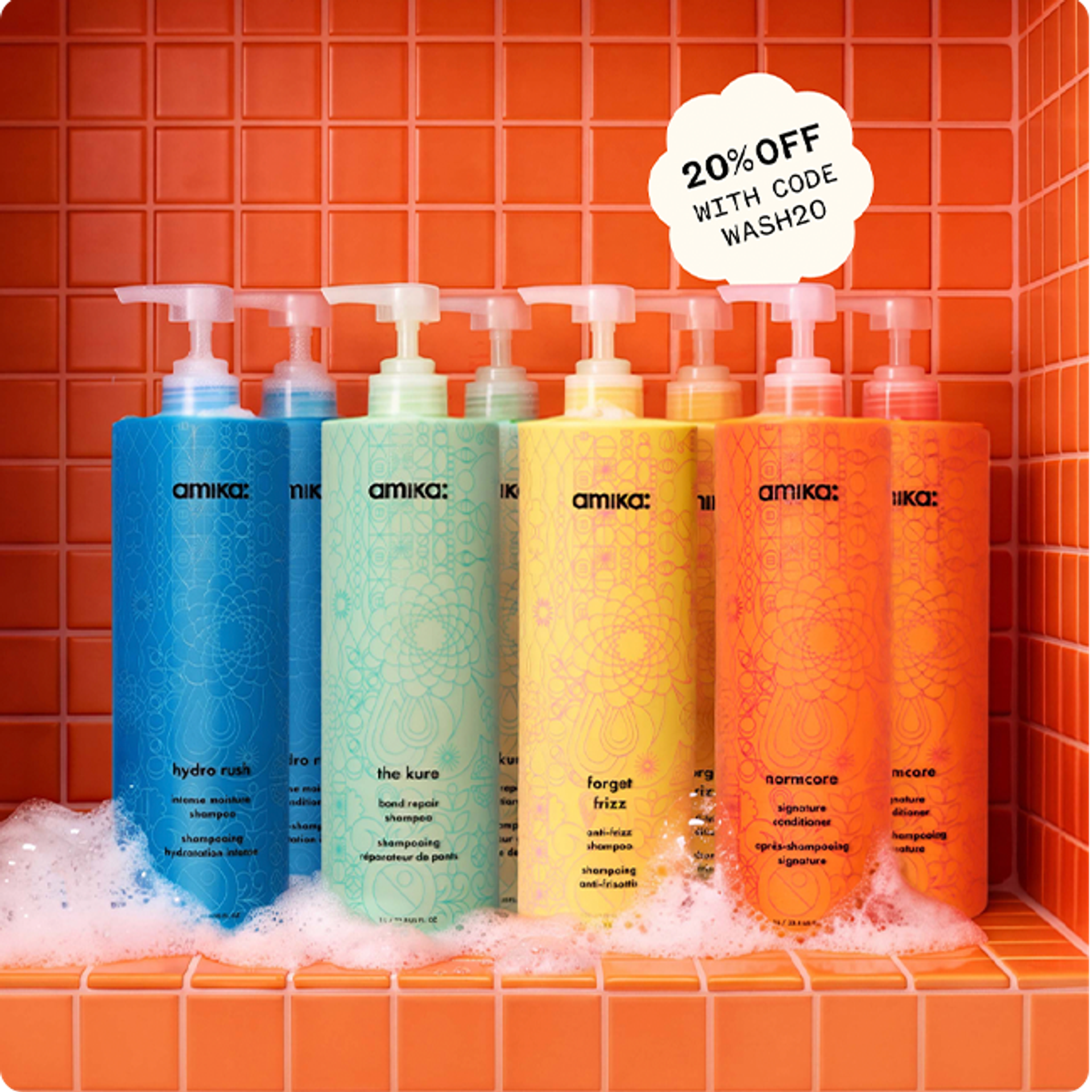 amika bottles of shampoo and conditioner against an orange tiled background with some suds at the bottom of the surface. a sticker reads: "20% OFF with code WASH20"