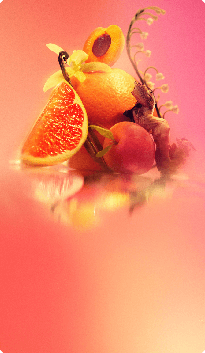 ingredient images of pink grapefruit, apricot, vanilla, lily of the valley and sandalwood on an pink background.