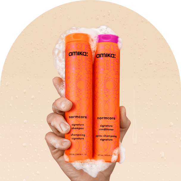 image of the normcore shampoo and conditioner with foams against a beige background.