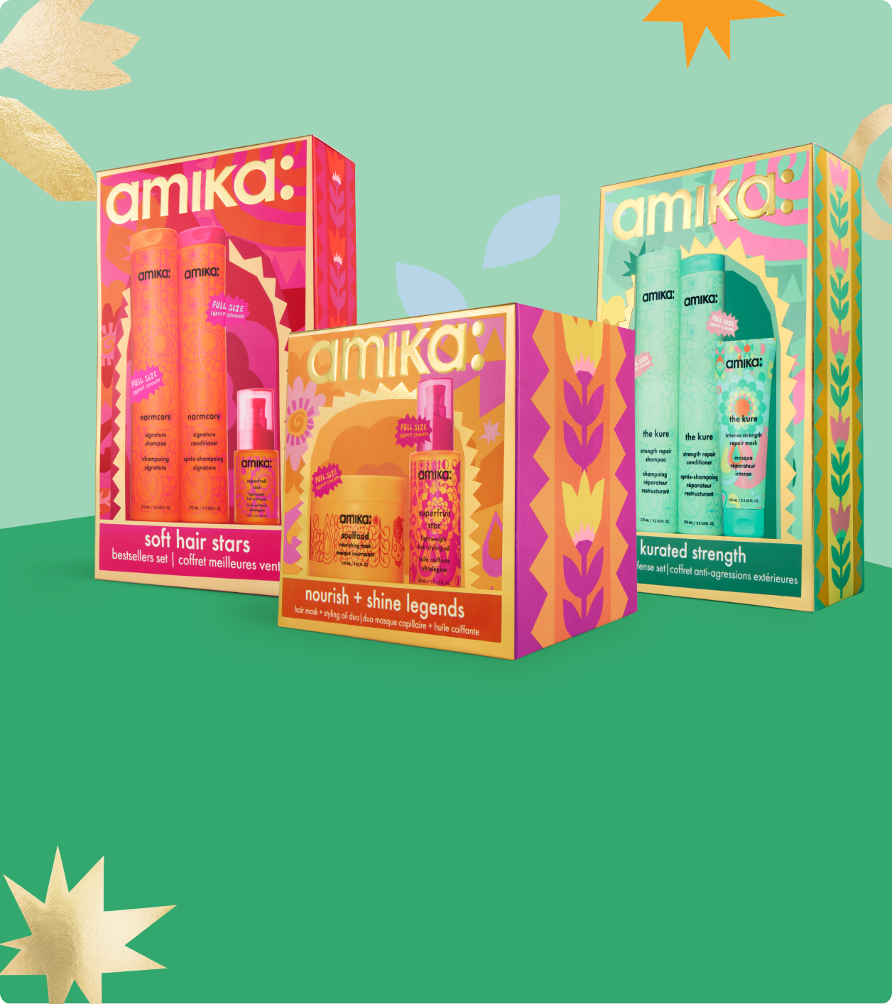 3 amika holiday gift sets against a green background with some pastel shapes behind them