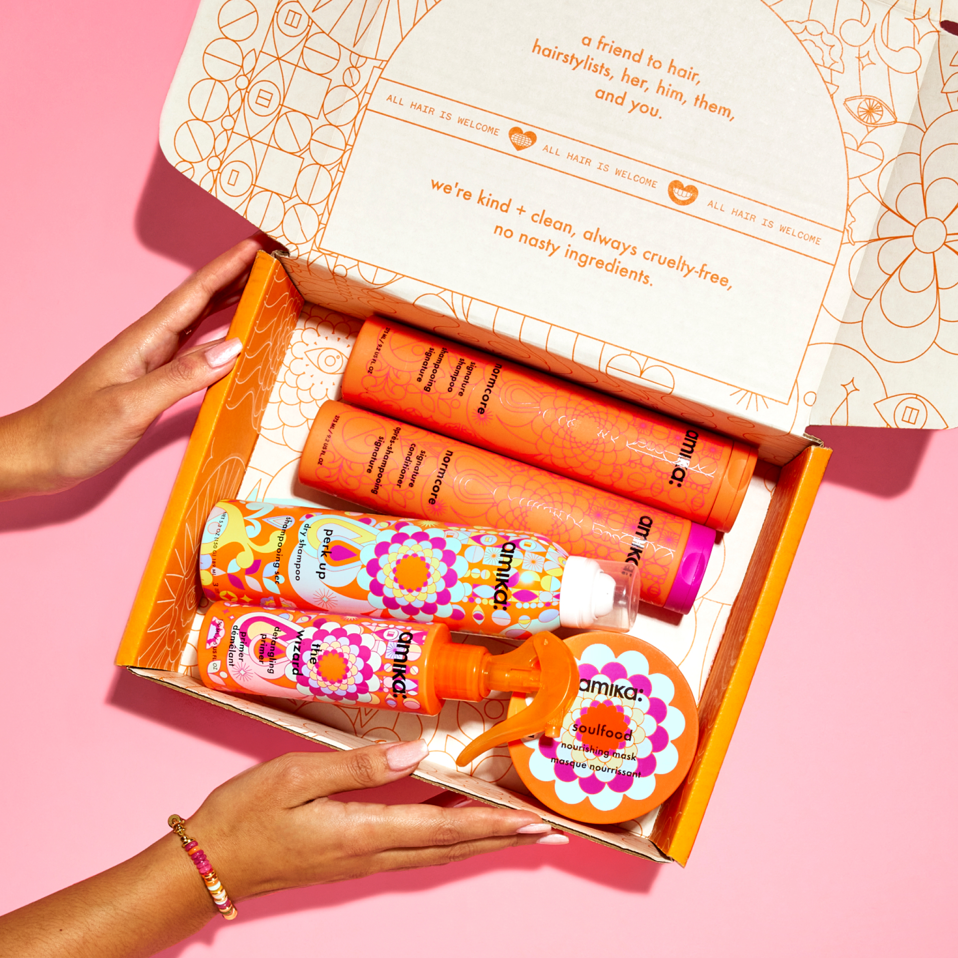 an amika mailer box with signature amika products including normcore shampoo and conditioner, perk up dry shampoo and wizard detangling primer and soulfood nourishing mask