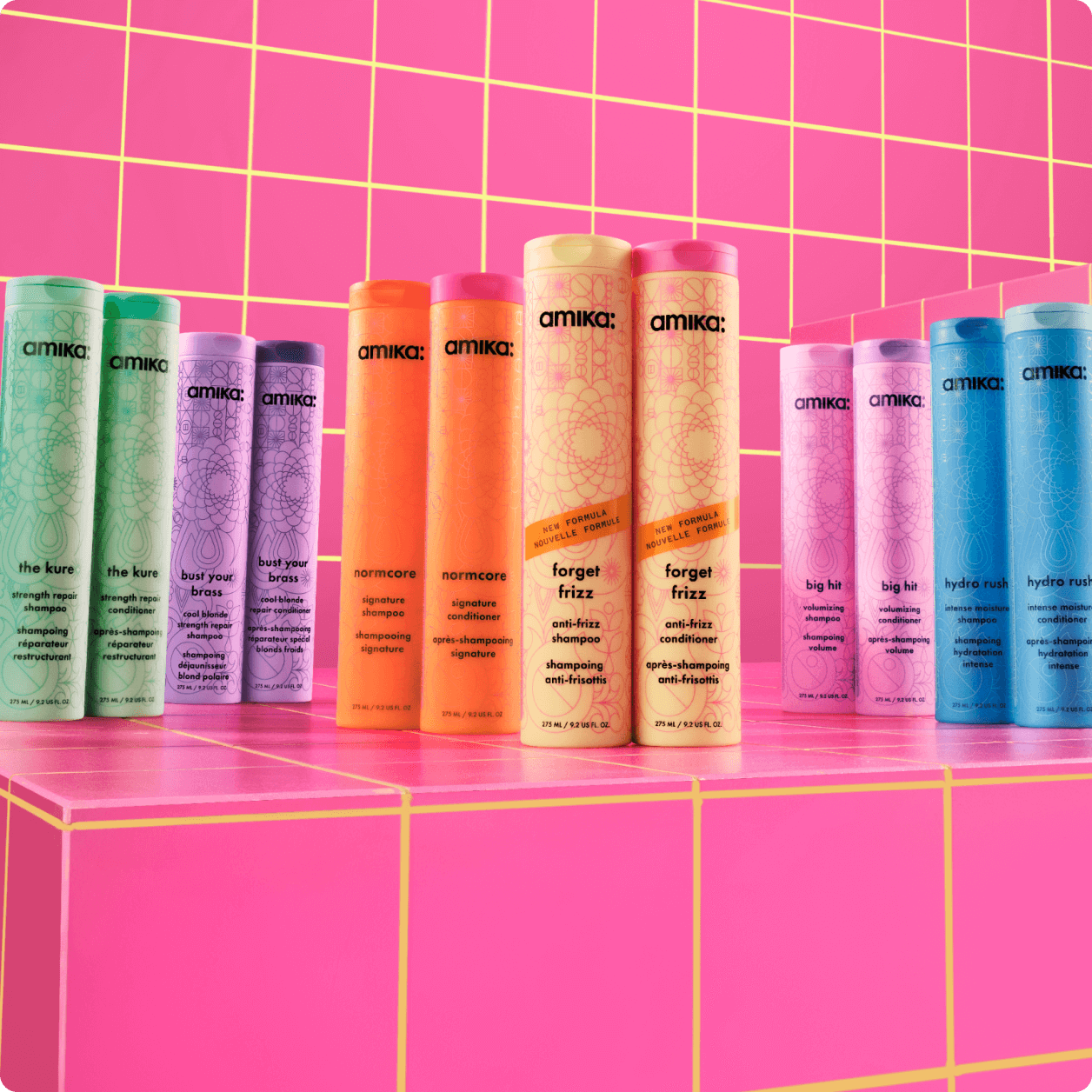 Image of amika's evergreen wash care duos. from left to right: kure strength repair shampoo and conditioner, bust your brass shampoo and conditioner, normcore shampoo and conditioner, forget frizz shampoo and conditioner, hydro rush shampoo and conditioner, and big hit shampoo and conditioner.