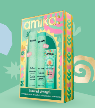 amika kurated strength holiday gift set posed against a light green background and with some gold shapes behind the box