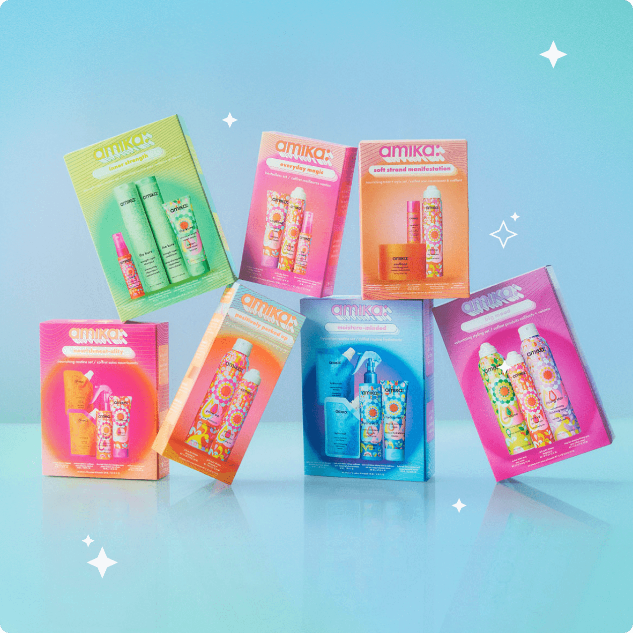 7 amika limited-edition holiday haircare gift sets are stacked against a blue background