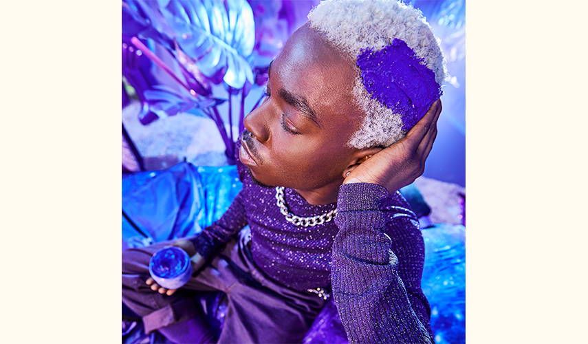 model applying bust your brass cool blonde intense repair mask