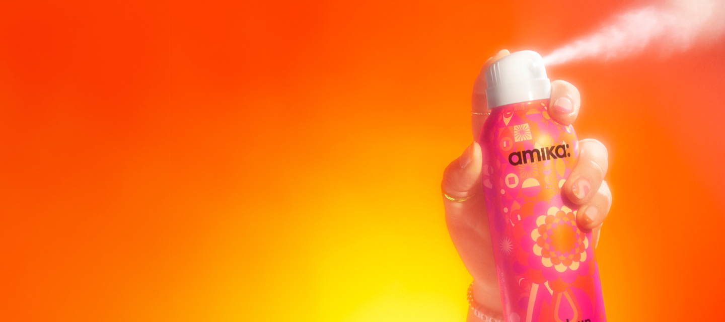 hand spraying perk up plus dry shampoo