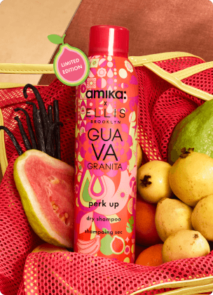 amika x Ellis Brooklyn limited-edition Guava Granita dry shampoo bottle in a mesh bag with fruit arranged around it