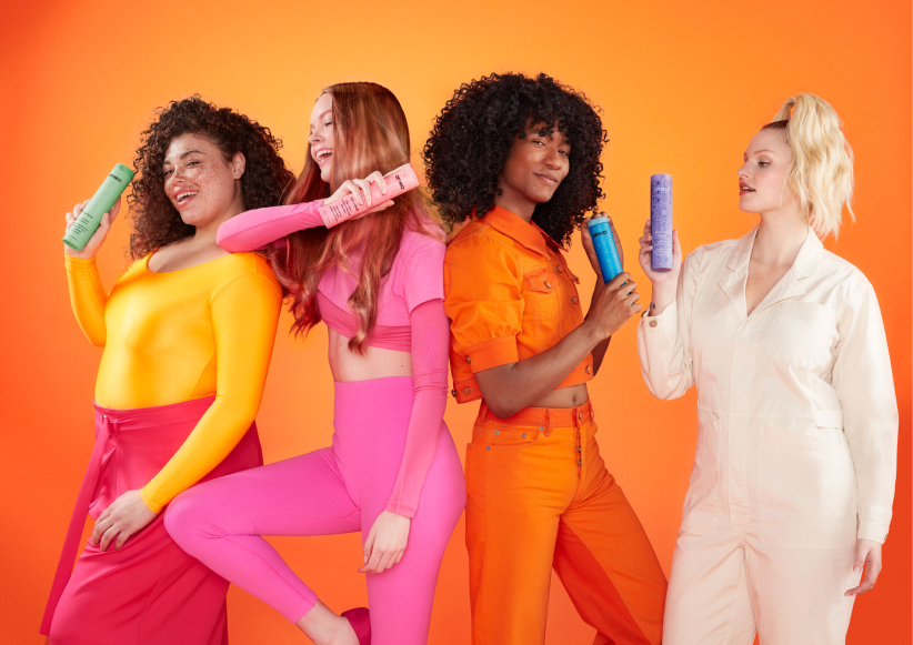 group of models holding different shampoo bottles
