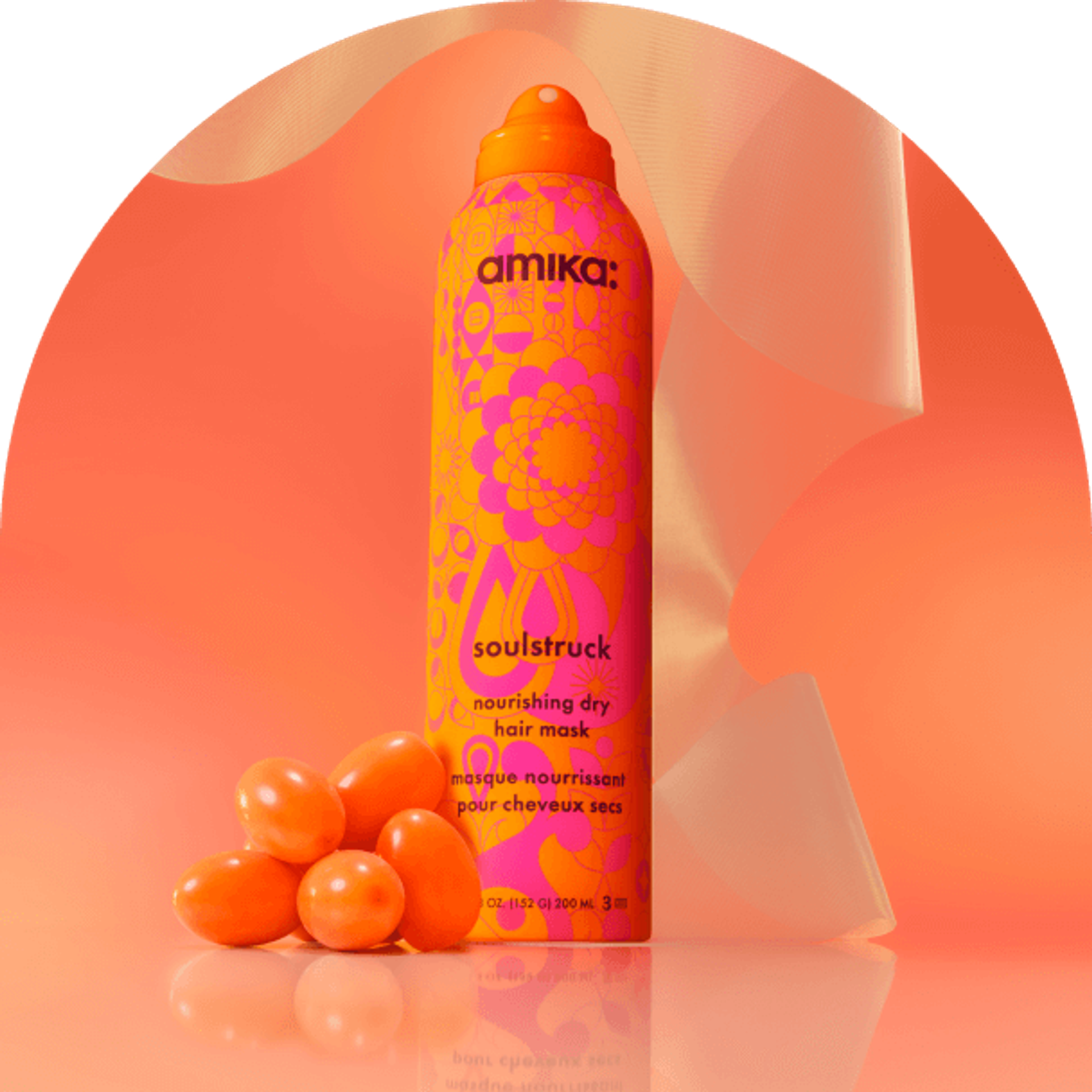 amika soulstruck spray and sea buckthorn berries in front of a amika products in front of a orange gradient background