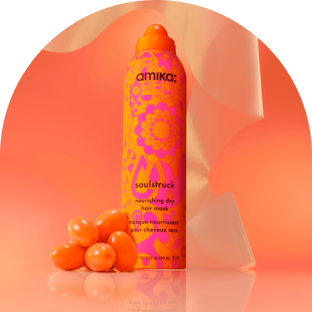amika soulstruck spray and sea buckthorn berries in front of a amika products in front of a orange gradient background
