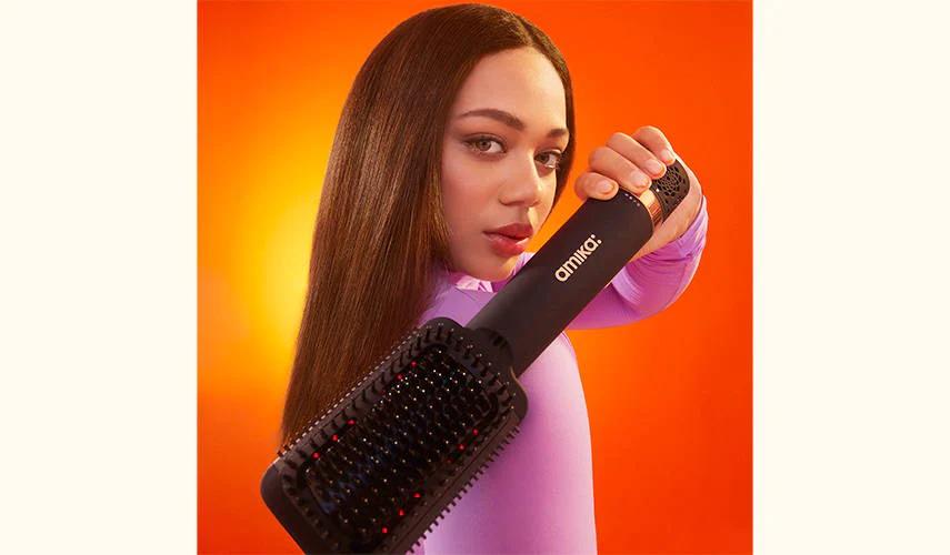 model holding double agent 2-in-1 blow dryer and straightening brush