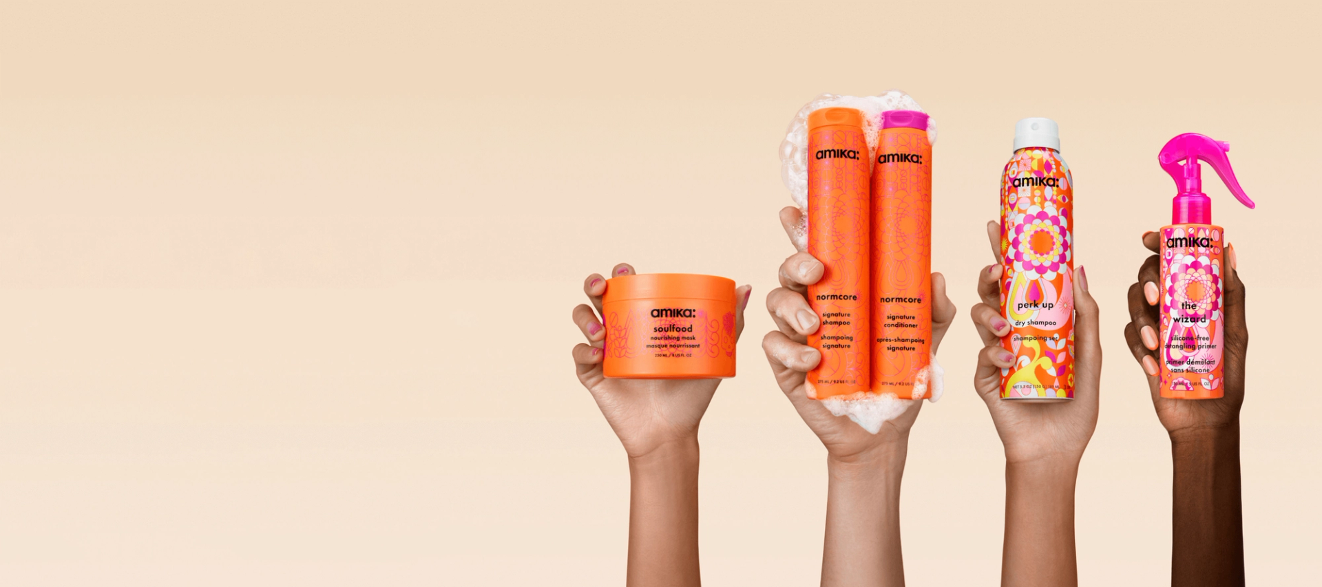 image of amika signature collection hero products: normcore shampoo + conditioner, perk up dry shampoo, the wizard detangling hair primer and soulfood nourishing hair mask against a cream background.