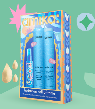 amika hydration hall of fame holiday gift set posed against a light green background and with some gold shapes behind the box